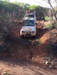 Greg takes his Jimmy through the creek.