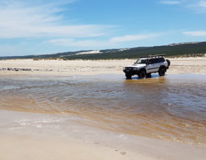 Graham takes his Patrol though the Warren River.