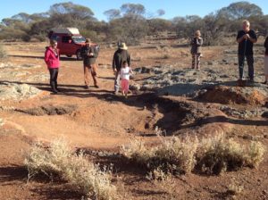 Ayesha tries water divining at Jimbine Rockhole.