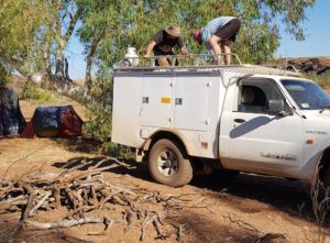 Unloading wood at the campsite.