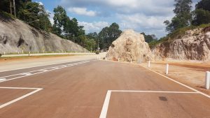 The highway is carved out of the mountains.