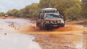 Matt in his Navara tows the trailer through the creek.